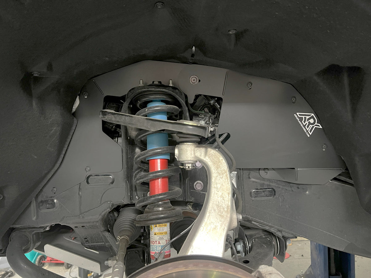 Ark splash guards installed behind the front wheel of a Toyota
