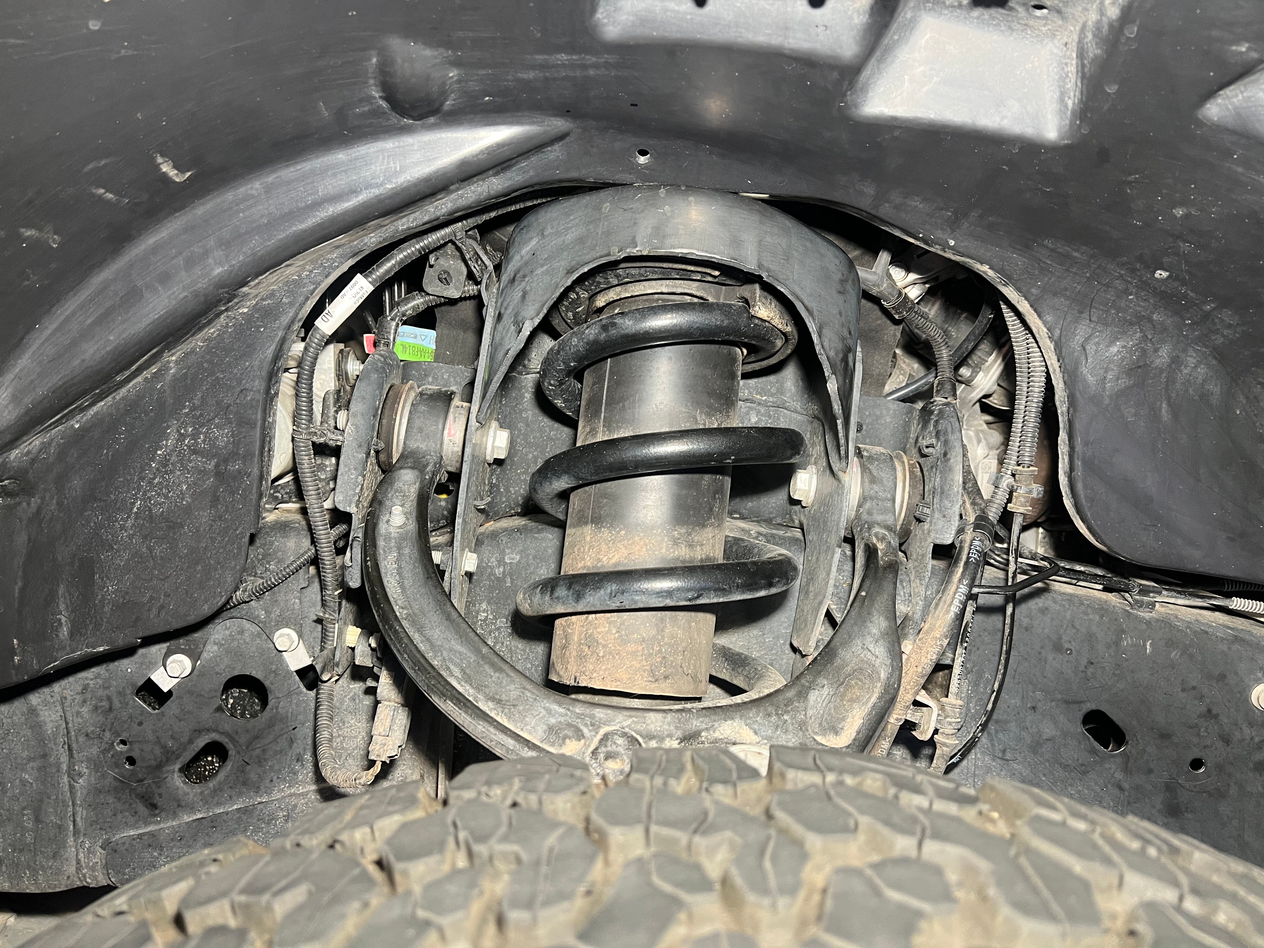 2017-2020 Ford Raptor Driver Side without Ark Splash Guards showing exposed components around the suspension
